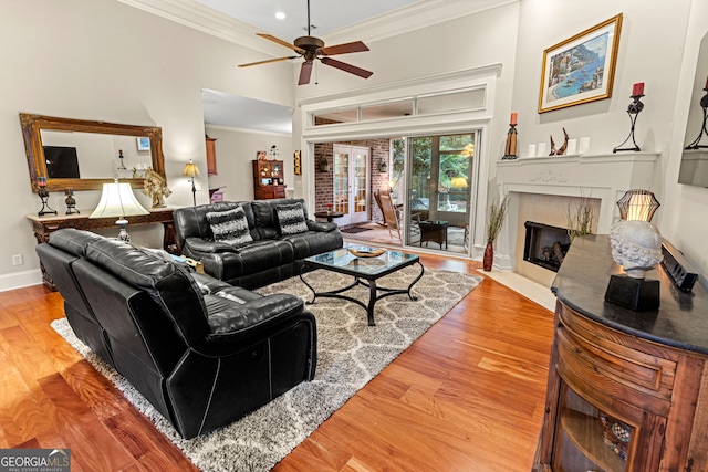 living room with ceiling fan, hardwood / wood-style floors, and ornamental molding