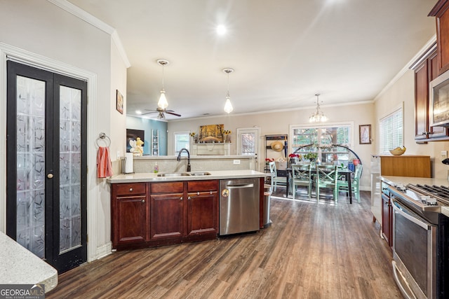 kitchen featuring crown molding, stainless steel appliances, decorative light fixtures, dark hardwood / wood-style floors, and sink