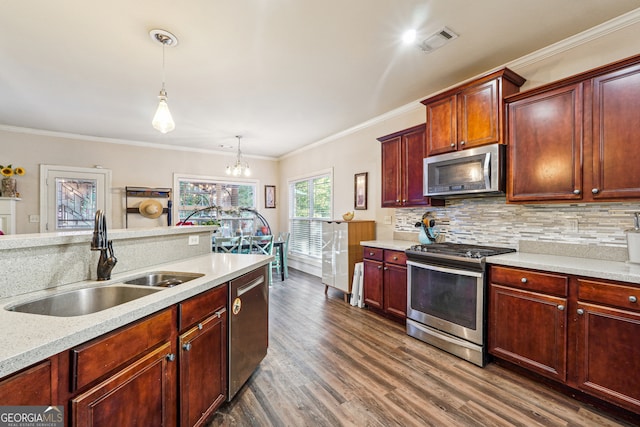 kitchen featuring crown molding, stainless steel appliances, pendant lighting, sink, and dark wood-type flooring