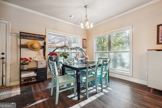 dining room featuring dark hardwood / wood-style flooring, a notable chandelier, and crown molding