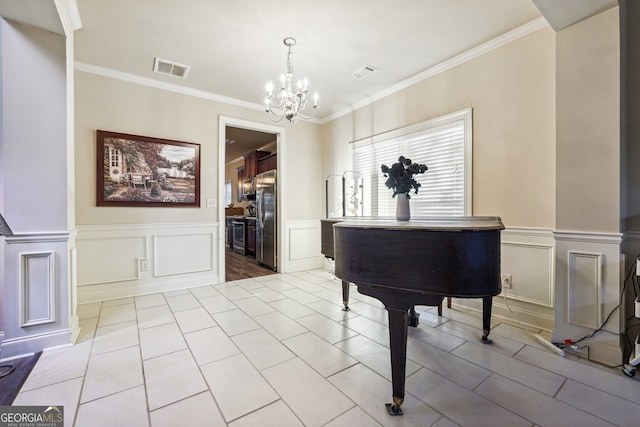 misc room featuring light tile patterned flooring, ornate columns, an inviting chandelier, and ornamental molding