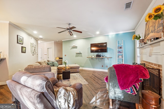 living room with a brick fireplace, ceiling fan, crown molding, and dark parquet floors