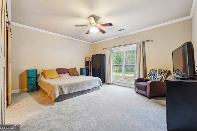 carpeted bedroom featuring ceiling fan and ornamental molding