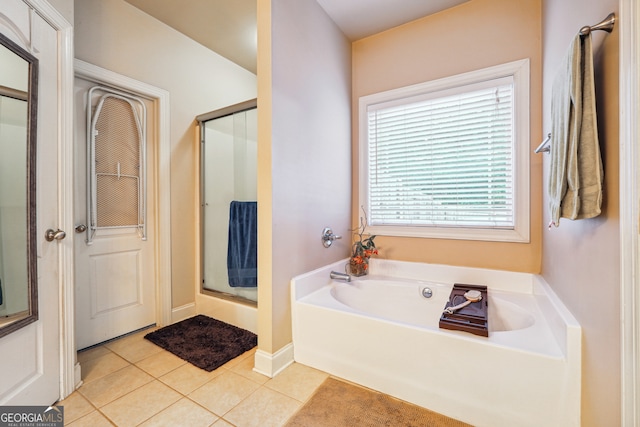 bathroom featuring tile patterned floors and shower with separate bathtub