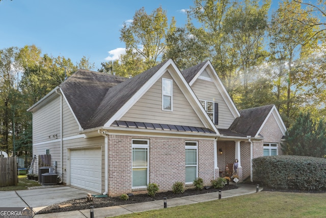 view of front of property featuring central air condition unit and a garage