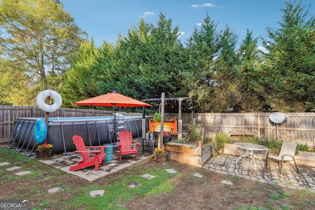 view of yard featuring a fenced in pool and a patio