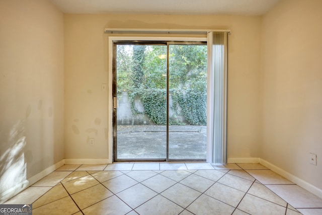 doorway to outside with light tile patterned flooring