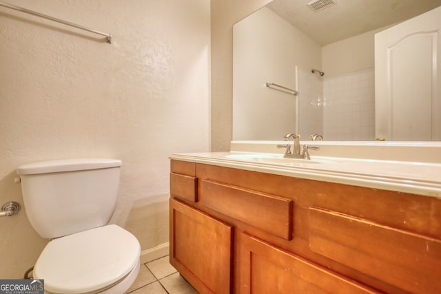 bathroom with vanity, tile patterned flooring, and toilet