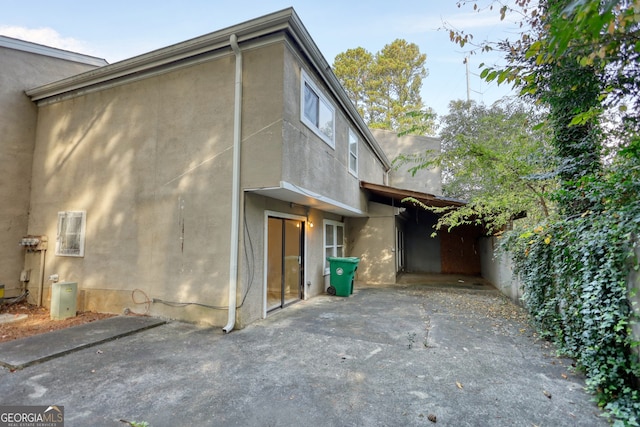 view of property exterior with a patio area