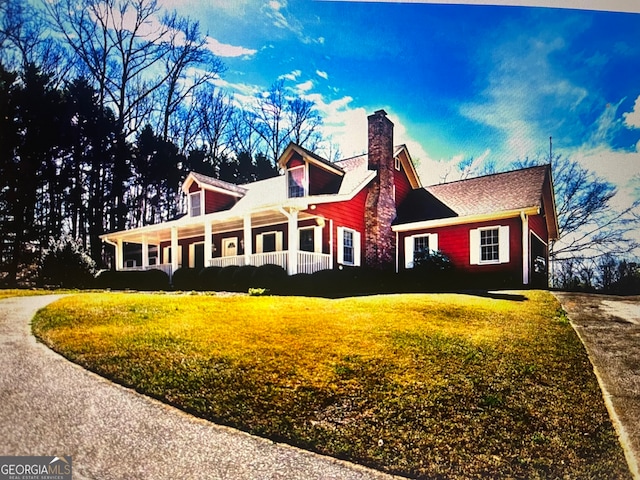 view of front facade featuring a front yard and covered porch