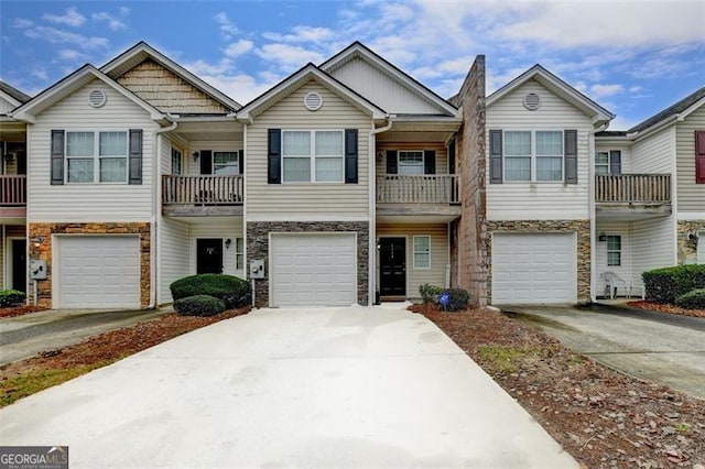 multi unit property with a garage and a balcony