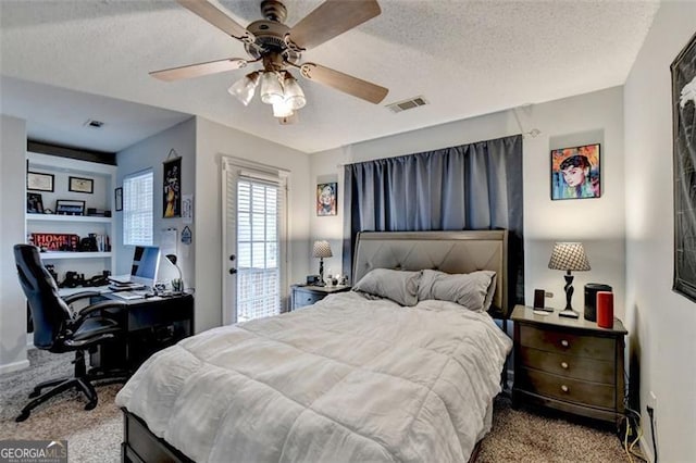 bedroom featuring a textured ceiling, access to outside, light colored carpet, and ceiling fan