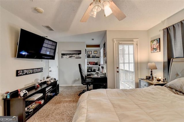 carpeted bedroom featuring a textured ceiling and ceiling fan