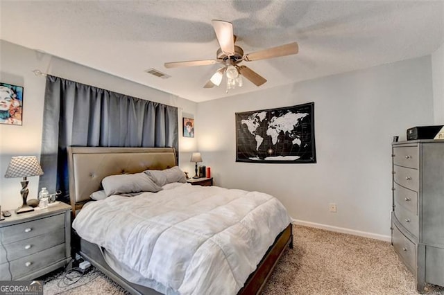 bedroom with a textured ceiling, light carpet, and ceiling fan