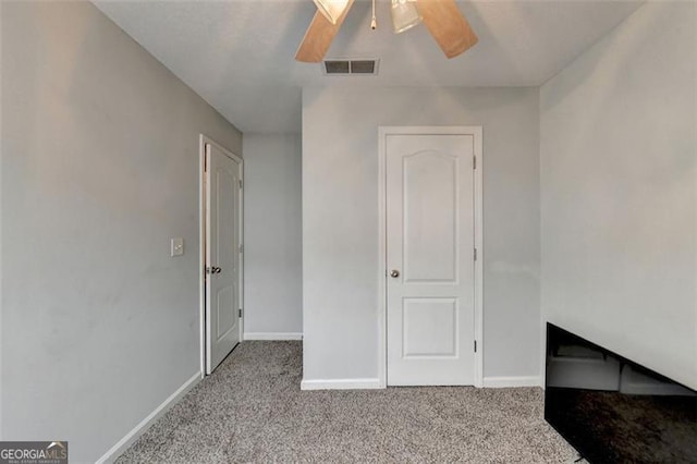 unfurnished bedroom with ceiling fan and light colored carpet