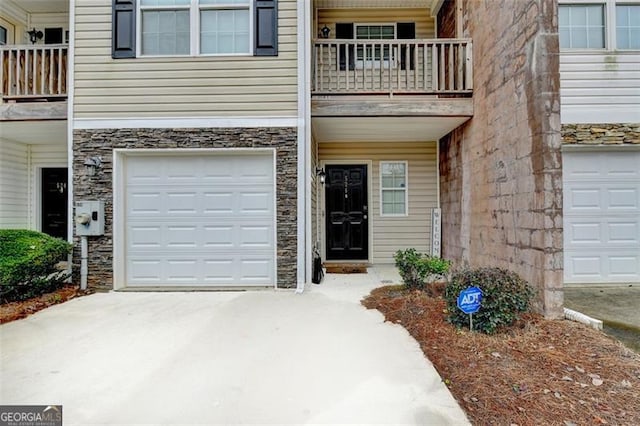 view of front of home featuring a balcony and a garage