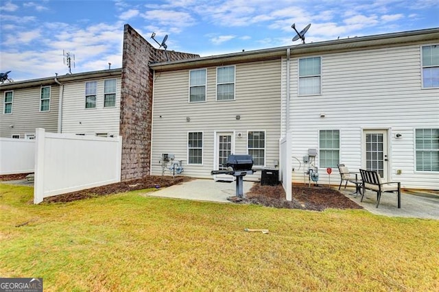 rear view of house with a patio area and a lawn