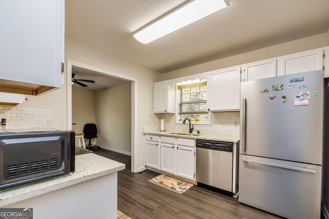 kitchen featuring white cabinets, tasteful backsplash, stainless steel appliances, and dark wood-type flooring