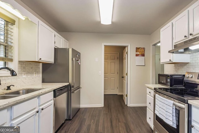 kitchen featuring white cabinetry, sink, stainless steel appliances, dark hardwood / wood-style flooring, and decorative backsplash