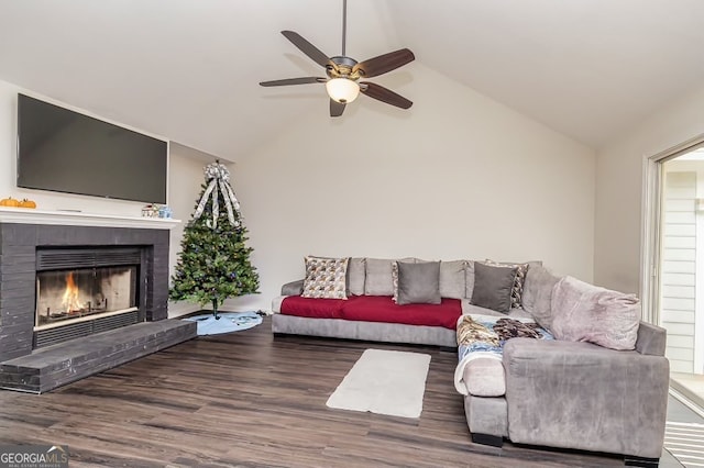 living room with a fireplace, hardwood / wood-style floors, vaulted ceiling, and ceiling fan