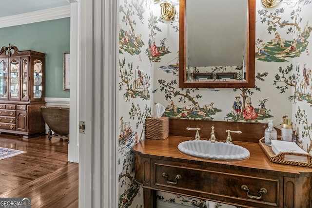 bathroom featuring vanity, hardwood / wood-style floors, and crown molding