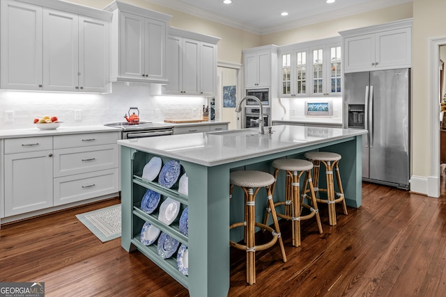 kitchen with white cabinetry, sink, a kitchen bar, stainless steel fridge with ice dispenser, and a center island with sink