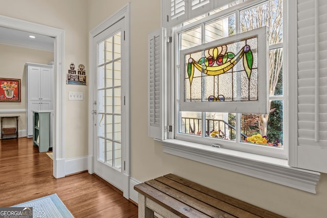 entryway featuring crown molding and light hardwood / wood-style floors