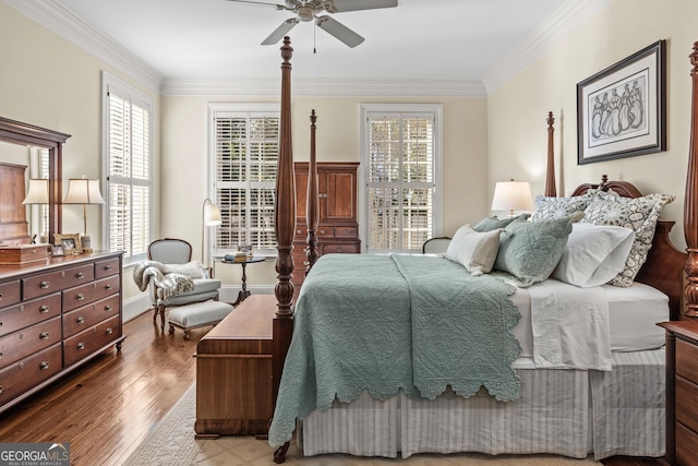 bedroom featuring wood-type flooring, ornamental molding, and ceiling fan