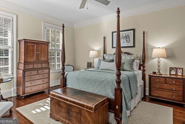 bedroom featuring dark wood-type flooring, ornamental molding, and ceiling fan