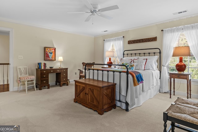 carpeted bedroom with crown molding and ceiling fan