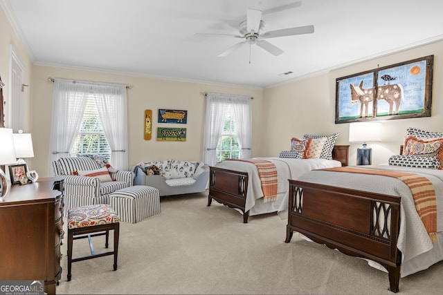 carpeted bedroom with ornamental molding and ceiling fan