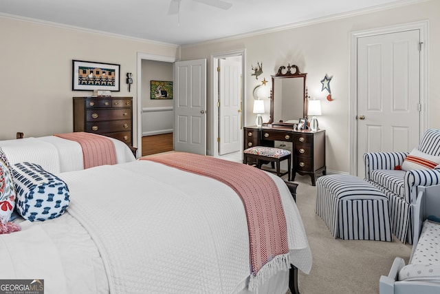 carpeted bedroom with ornamental molding and ceiling fan