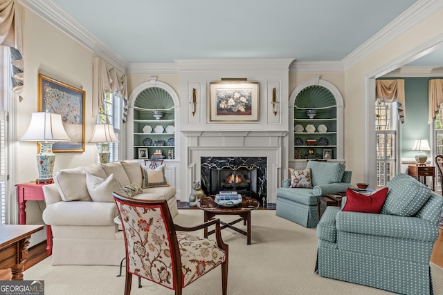 living room featuring crown molding, a premium fireplace, and built in features