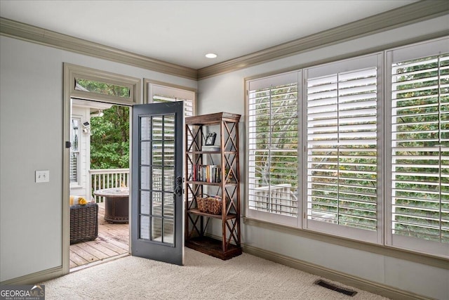 doorway to outside featuring light colored carpet and ornamental molding