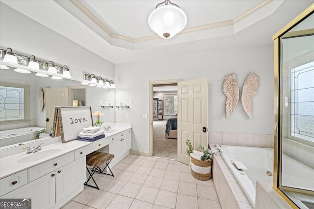 bathroom featuring tile patterned floors, tiled tub, vanity, a raised ceiling, and crown molding