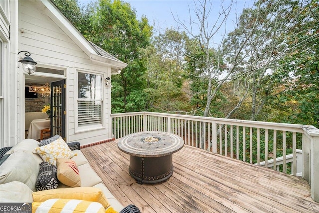 wooden terrace with an outdoor fire pit