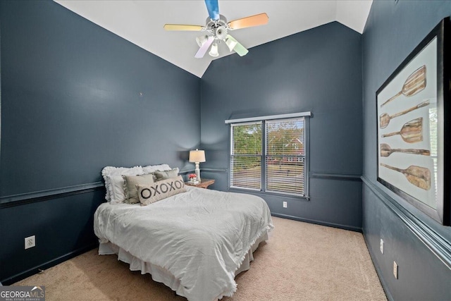 carpeted bedroom featuring lofted ceiling and ceiling fan