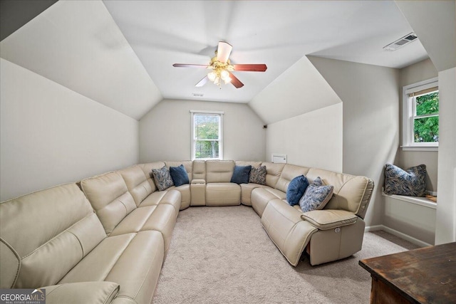 carpeted living room with ceiling fan and vaulted ceiling