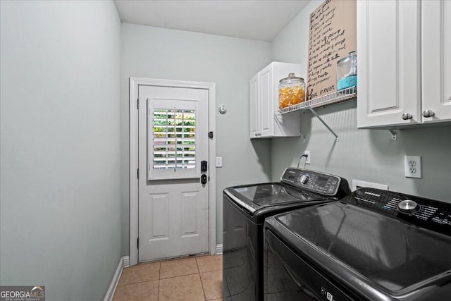 laundry room featuring cabinets, washing machine and clothes dryer, and light tile patterned floors