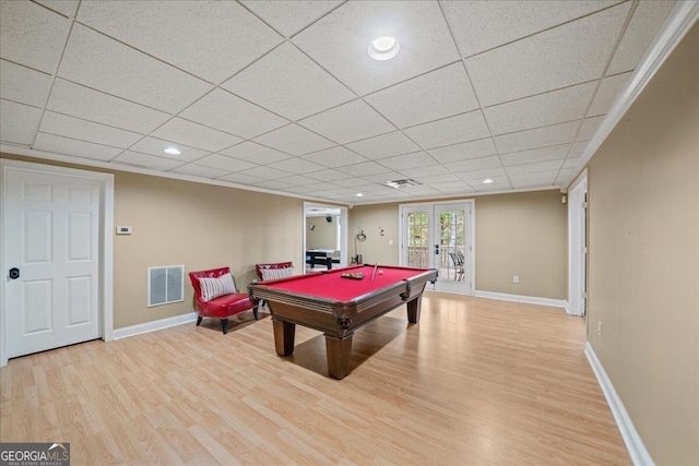 game room with pool table, french doors, light hardwood / wood-style flooring, and a paneled ceiling