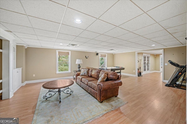 living room featuring pool table, light hardwood / wood-style floors, and a paneled ceiling