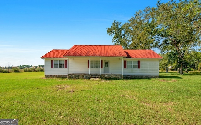 rear view of house featuring a lawn