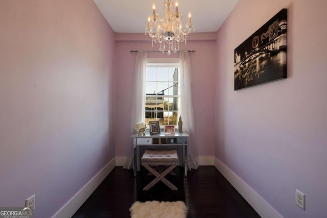 dining area featuring dark hardwood / wood-style flooring and a notable chandelier