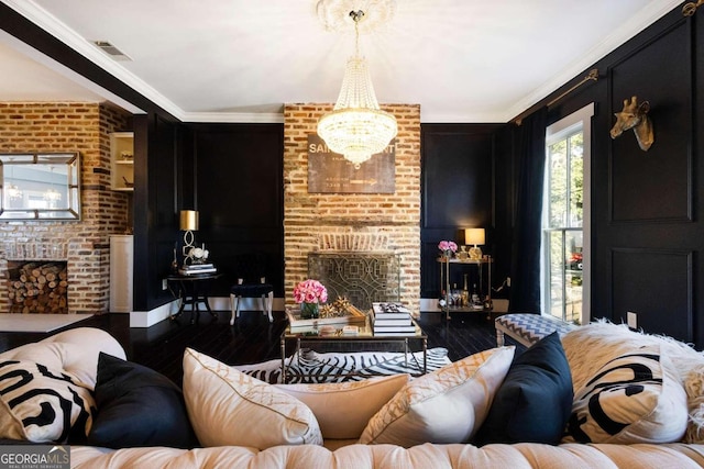 living room featuring brick wall, a chandelier, hardwood / wood-style flooring, and crown molding