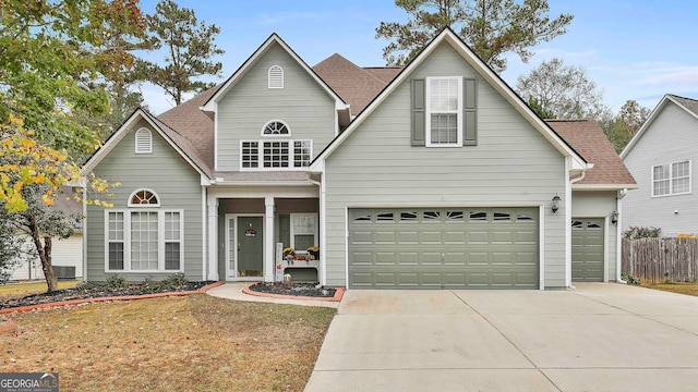 front of property featuring a garage and central AC