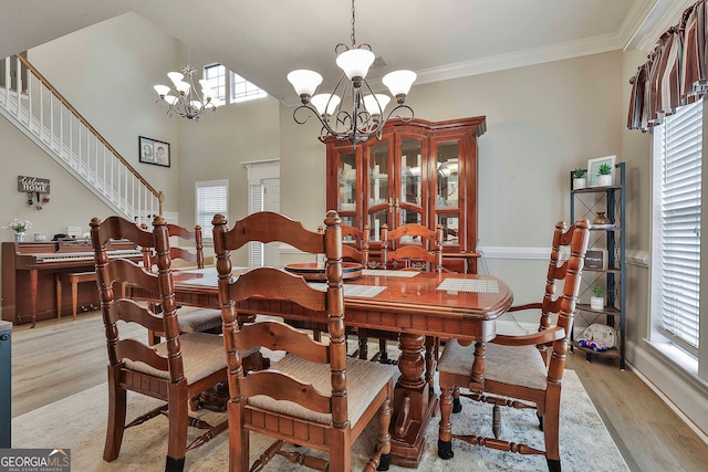 dining room featuring a wealth of natural light, a chandelier, and light hardwood / wood-style flooring