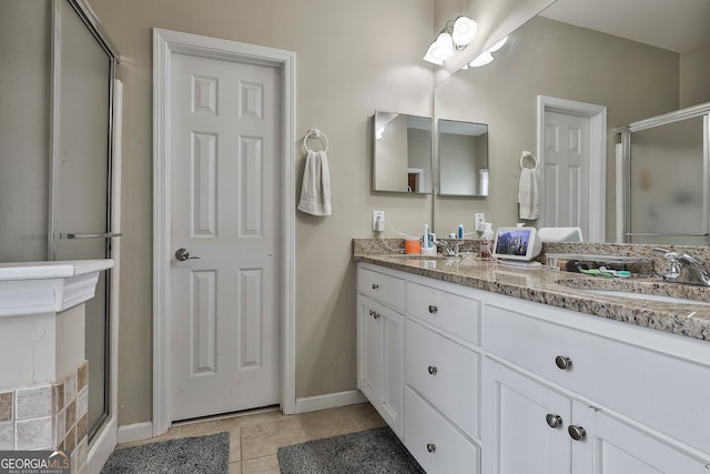 bathroom with tile patterned flooring, vanity, and a shower with shower door