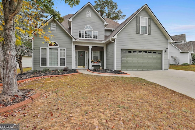 view of front property featuring a front lawn and a garage