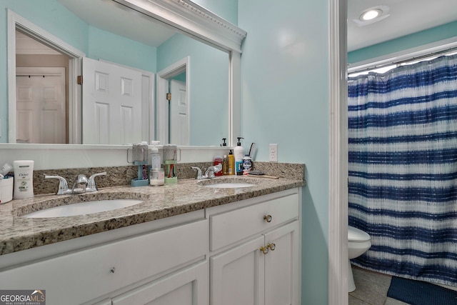 bathroom featuring walk in shower, vanity, and toilet