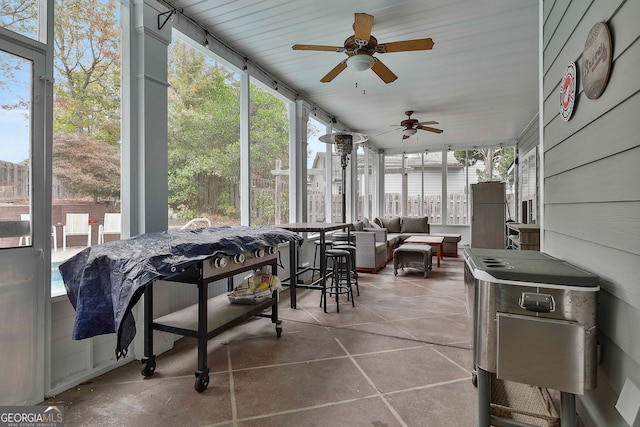 sunroom / solarium featuring a wealth of natural light and ceiling fan